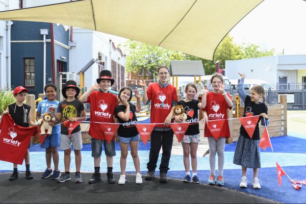 children standing in line holding bunting