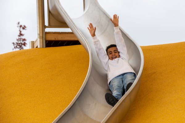 Boy goes down slide