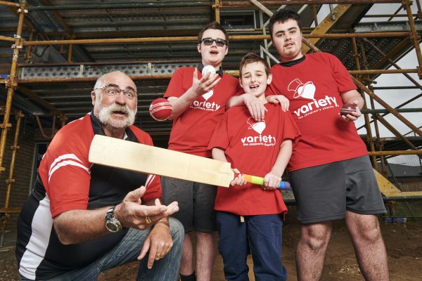 Cricket Star Merv Hughes and Three Young Boys wearing Red tshirts with Variety the Children's Charity logo on them