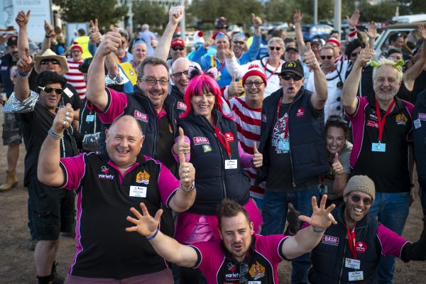 Group of people excitedly with their arms in the air