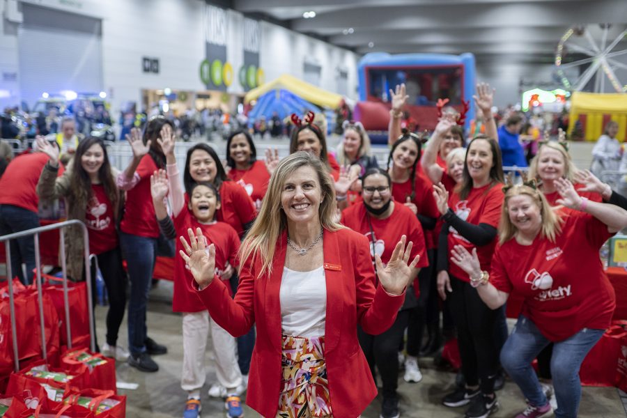 Mandy Burns, CEO of Variety Victoria, poses with Variety Volunteers at MCEC at Variety Kids Xmas Party 2022